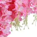 GoHooked pink silk wisteria vine garland with delicate petals and green stems, perfect for wedding decor.