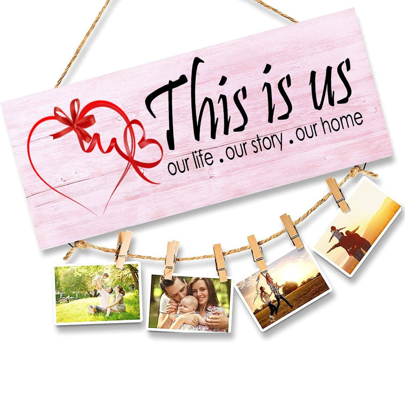 GoHooked pink wooden sign with 'This is us our life . our story . our home' and a red heart graphic. Holds 4 photos on a string.