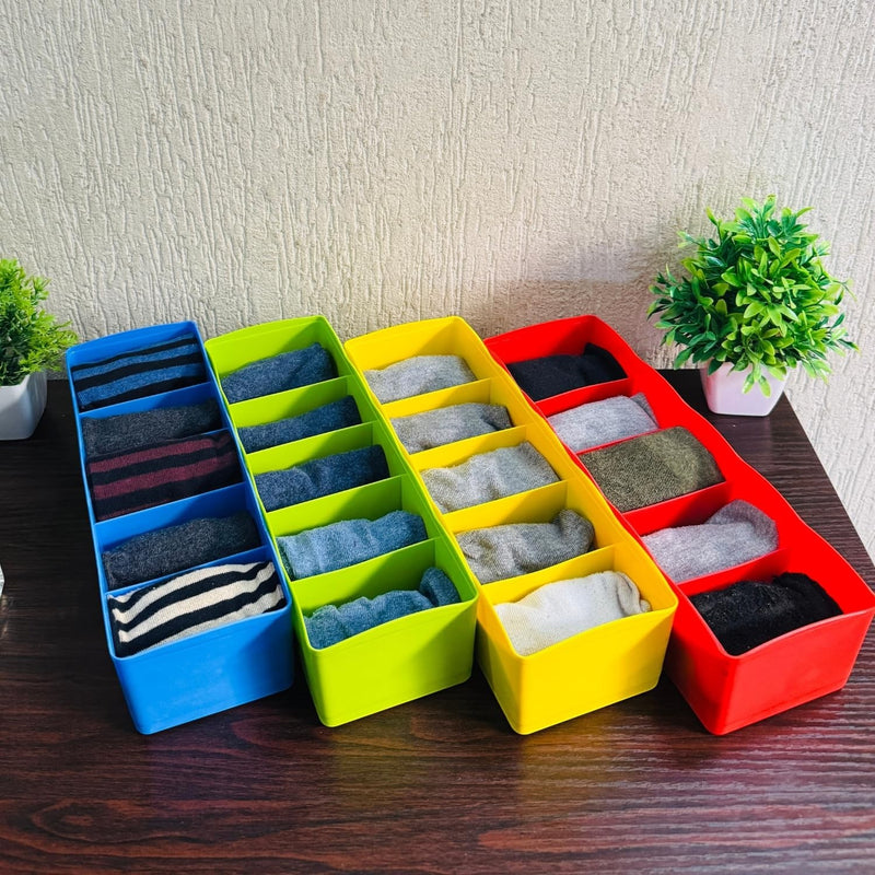 GoHooked set of 4 multicoloured plastic drawer organisers filled with socks. Blue, lime green, yellow, and red organisers.