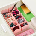 GoHooked pink plastic 5-grid drawer organizer set of 8, holding jewelry and hair accessories.