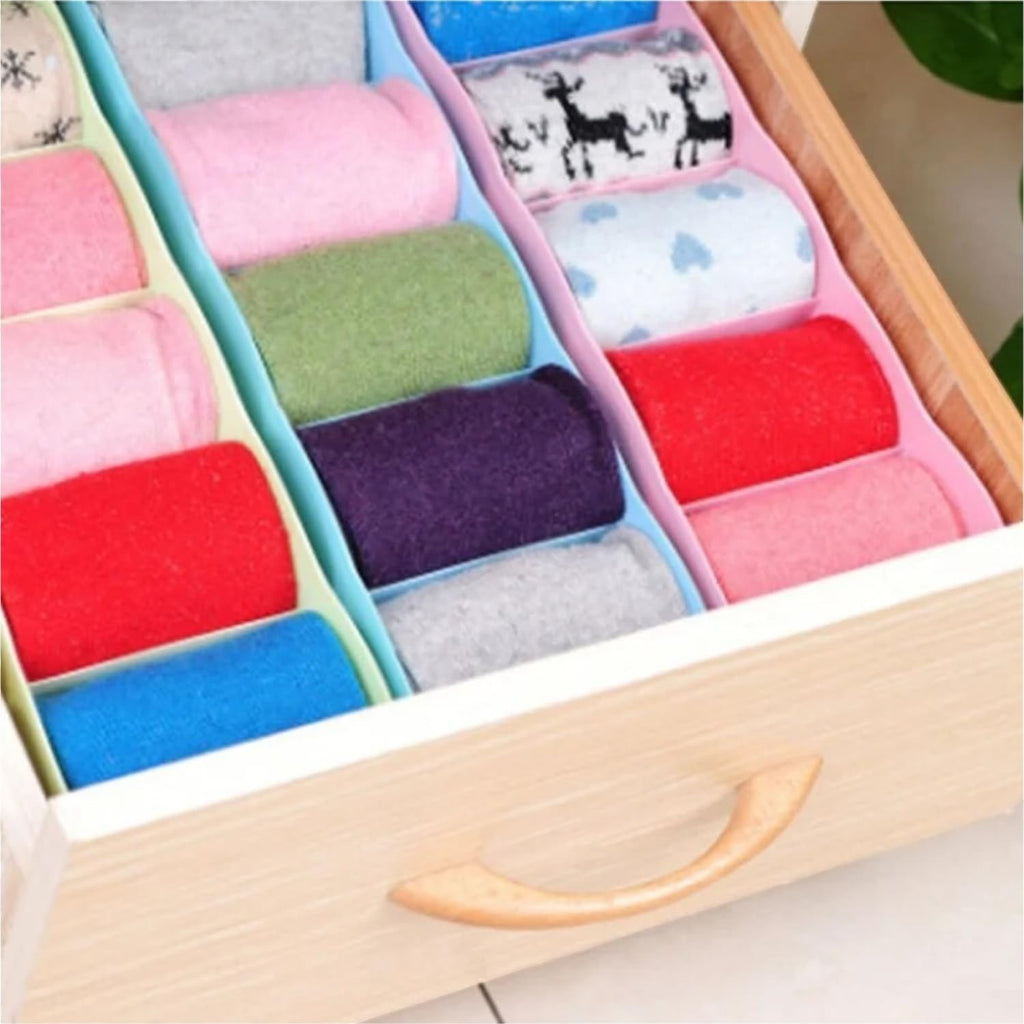 Go Hooked multicolour plastic 5-grid drawer organiser filled with rolled socks in various colours and patterns.