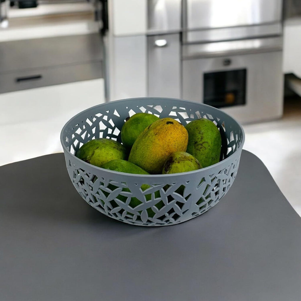 GoHooked light grey plastic fruit bowl with decorative cutouts, holding green and yellow fruit.