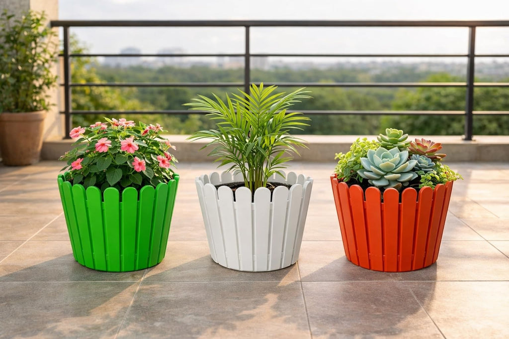 GoHooked set of 3 multicolor plastic garden planters with scalloped edges, holding pink flowers, a palm, and succulents.