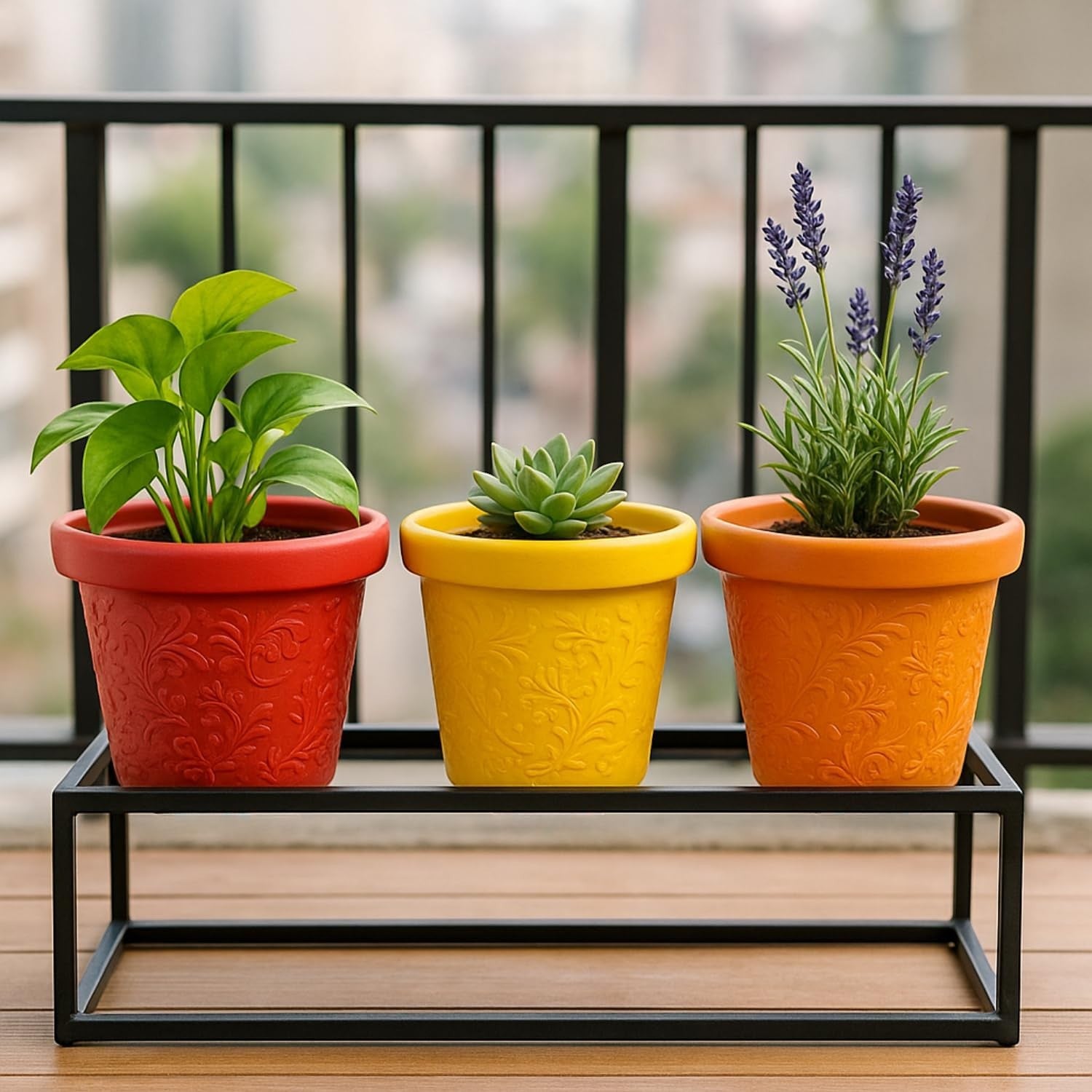 GoHooked set of 3 multicolor plastic planter pots with embossed floral design. Red, yellow, and orange pots on a black stand.