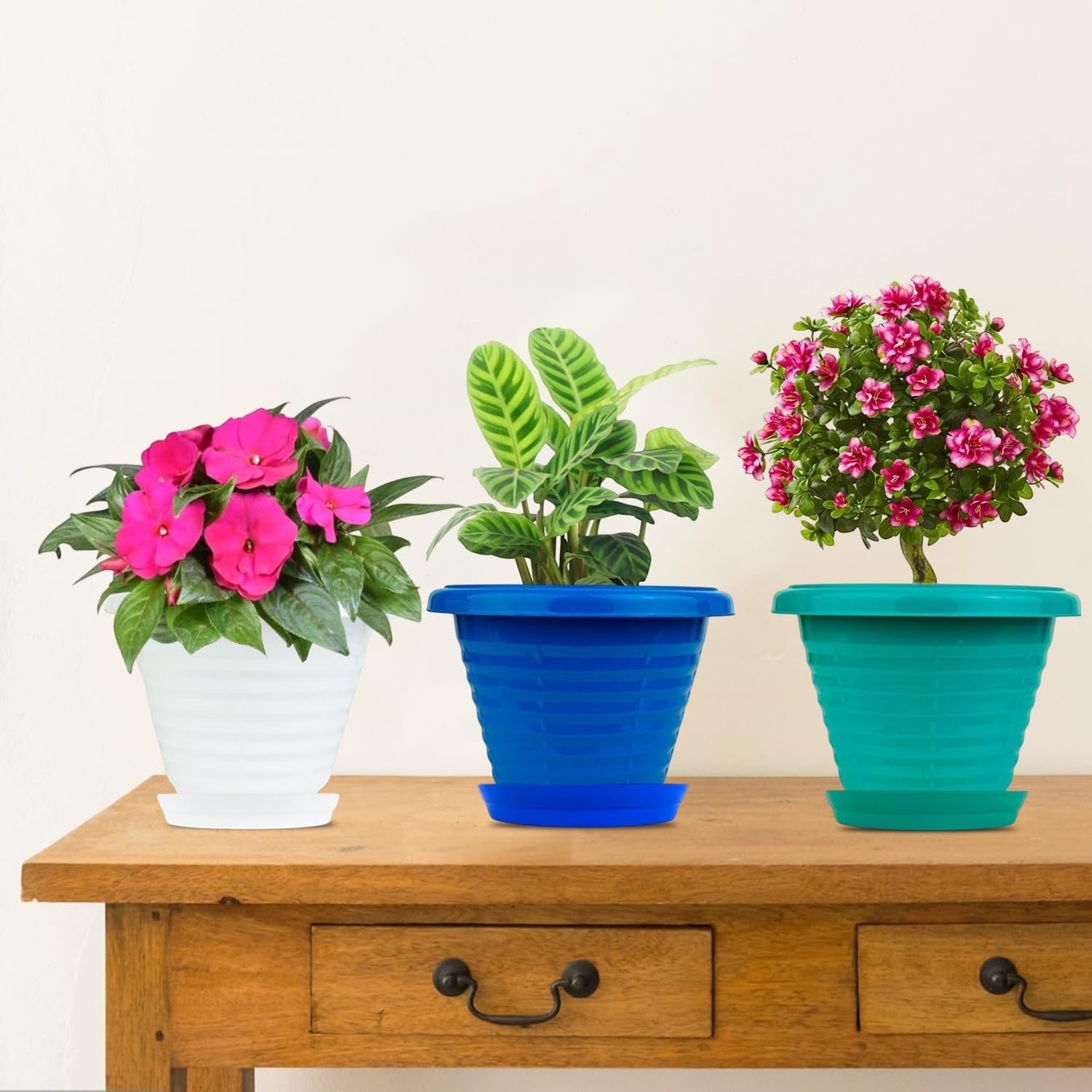 GoHooked set of 3 multicolor plastic planter pots with saucers, featuring white, blue, and teal pots with plants.