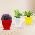 GoHooked set of 3 multicolour plastic planter pots with saucers, featuring a diamond-patterned design. Includes red, white, and yellow pots.