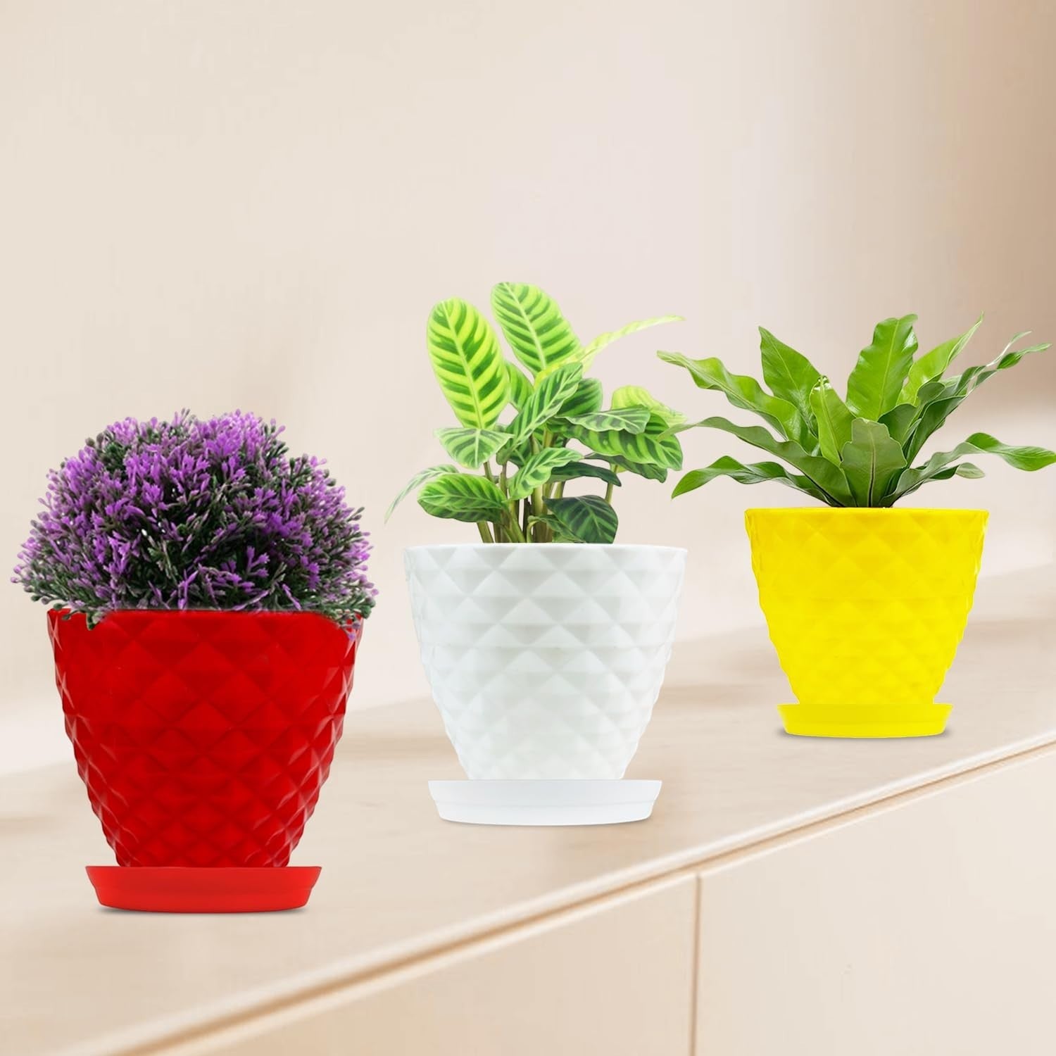 GoHooked set of 3 multicolour plastic planter pots with saucers, featuring a diamond-patterned design. Includes red, white, and yellow pots.