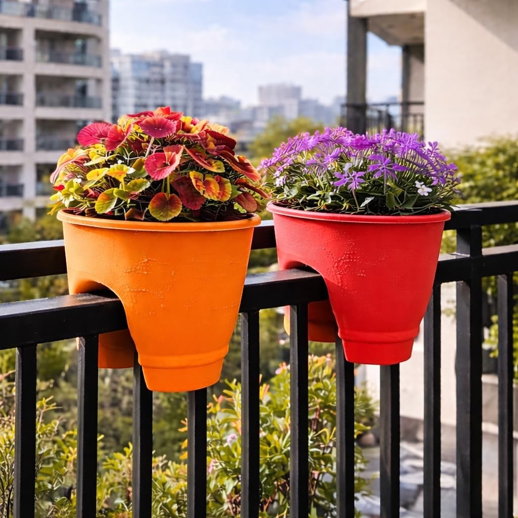 Go Hooked orange and red 12-inch plastic railing planters with colorful flowers on a balcony.