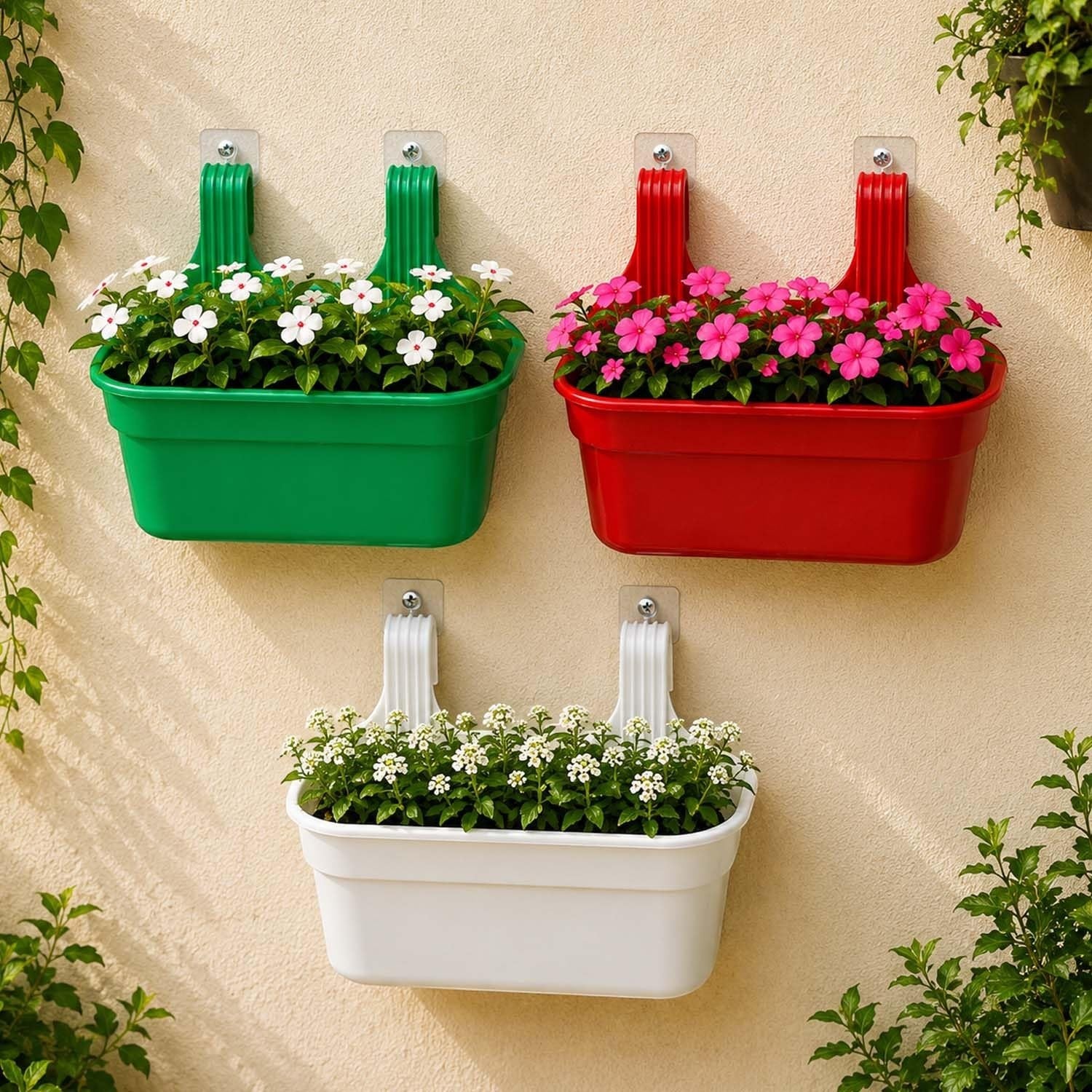 GoHooked set of 3 rectangular plastic railing planters in green, red, and white, holding flowering plants.