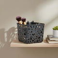 GoHooked dark grey plastic storage basket with cutout design, holding makeup brushes and pens.