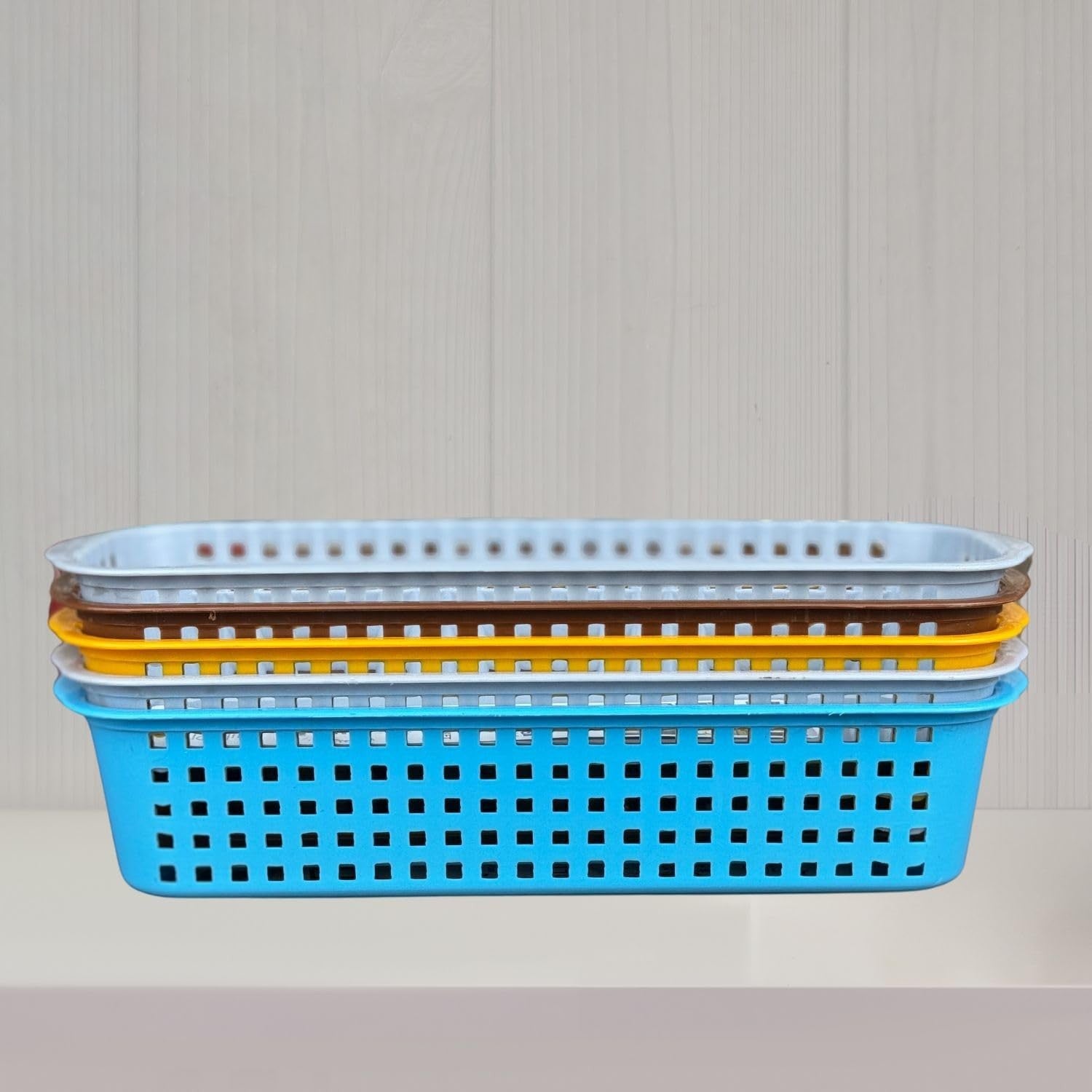Go Hooked plastic storage baskets in blue, yellow, brown, and white. Pack of 5, ideal for bathroom organization.