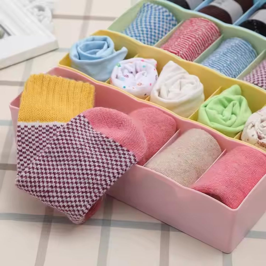 GoHooked multicolour plastic 5-grid drawer organiser box filled with rolled socks and underwear.