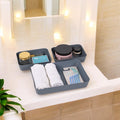 GoHooked set of 3 dark grey plastic storage trays organizing bathroom essentials like floss, towels, and razors.