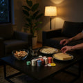 Go Hooked 200 multicolor poker chips, cards, and gaming mat on a coffee table with snacks.