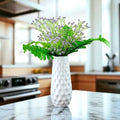 GoHooked white textured vase with purple baby's breath artificial flowers and green fern leaves.