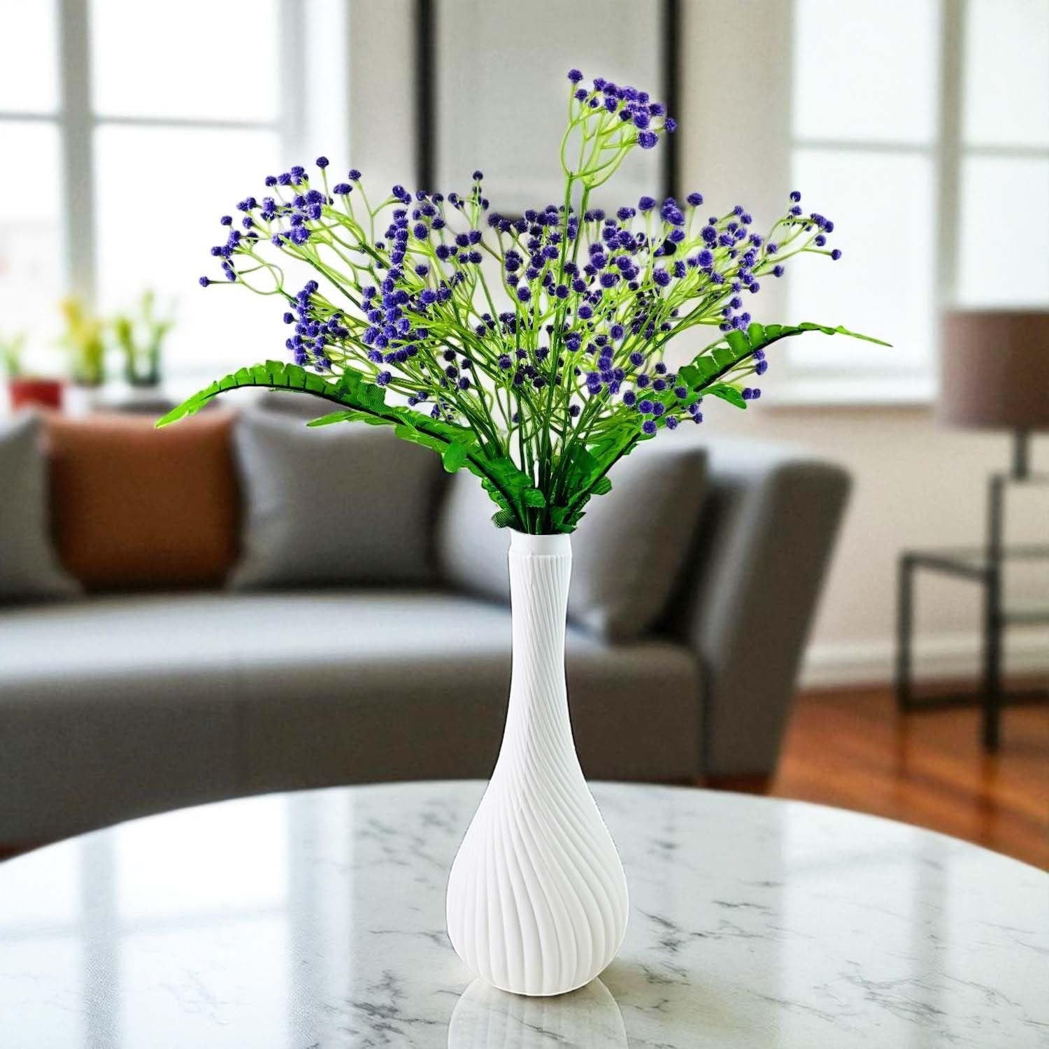 Go Hooked purple baby's breath artificial flowers with fern leaves in a white swirl vase on a marble table.