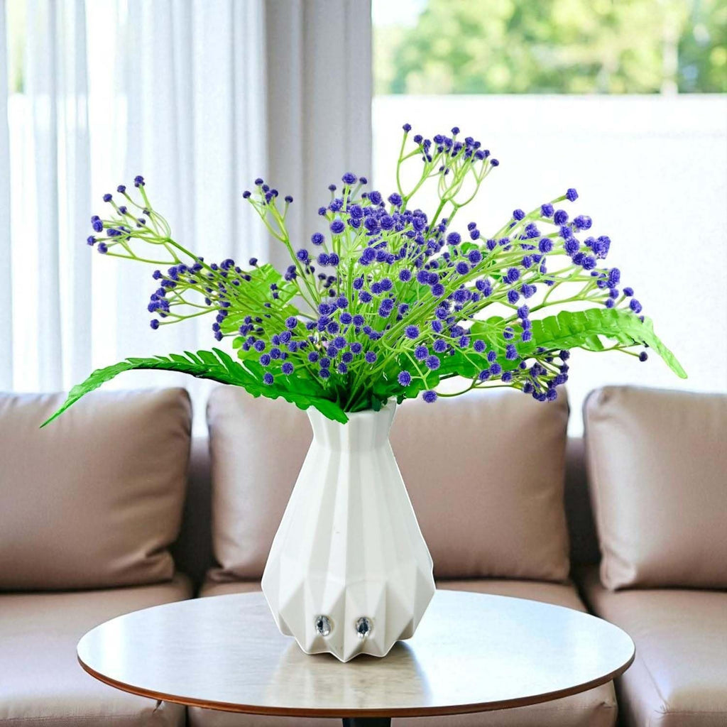 Go Hooked purple baby's breath artificial flowers with green fern leaves in a white geometric vase.