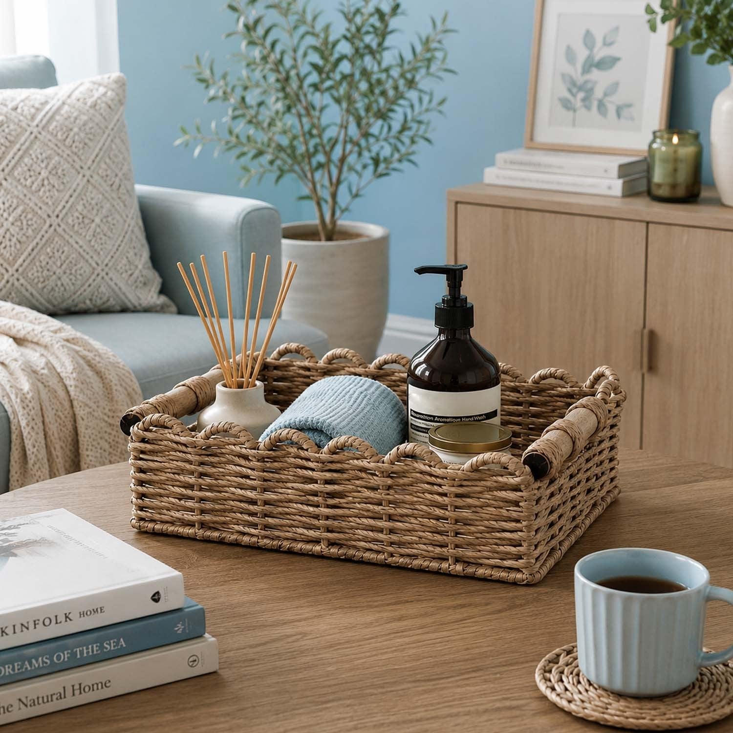 GoHooked rectangular raffia storage basket with wooden handles and metal frame on a wooden table in a living room.