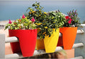GoHooked railing planters in red, yellow, and orange, made of plastic, perfect for balconies.