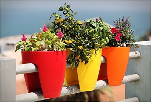 GoHooked 12-inch railing planters in red, yellow, and orange, made of plastic, holding various flowers and plants.