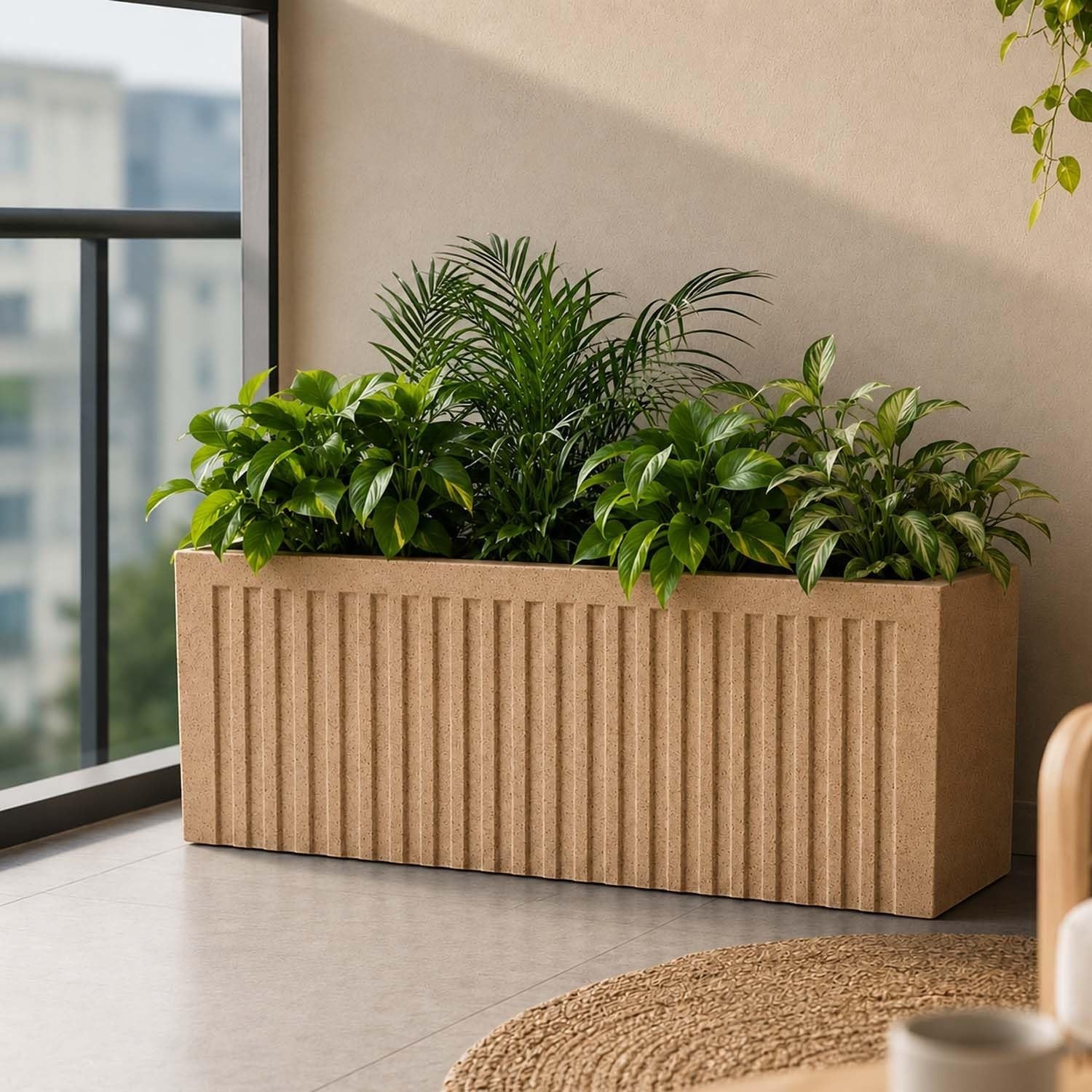 GoHooked 24-inch rectangular polymer planter pot with vertical ribbed texture in a light beige color, filled with lush green plants.
