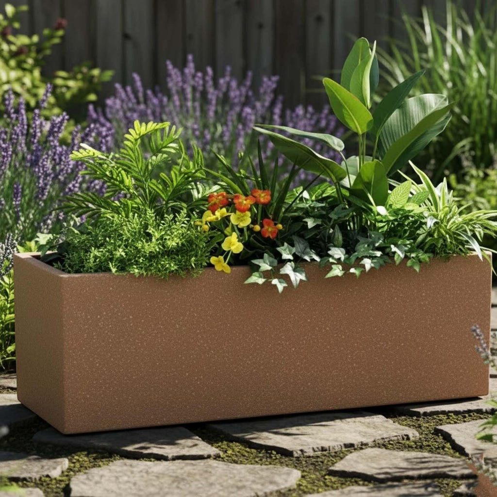 GoHooked rectangular sandstone polymer planter filled with lush green plants and colorful flowers on a stone patio.