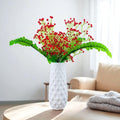GoHooked red artificial baby's breath flowers in a textured white vase. Realistic rubber flower heads and plastic stems.