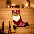 Go Hooked red Christmas stocking with Santa face, snowflake pattern, and faux fur trim. Festive decor for trees, walls, and doors.
