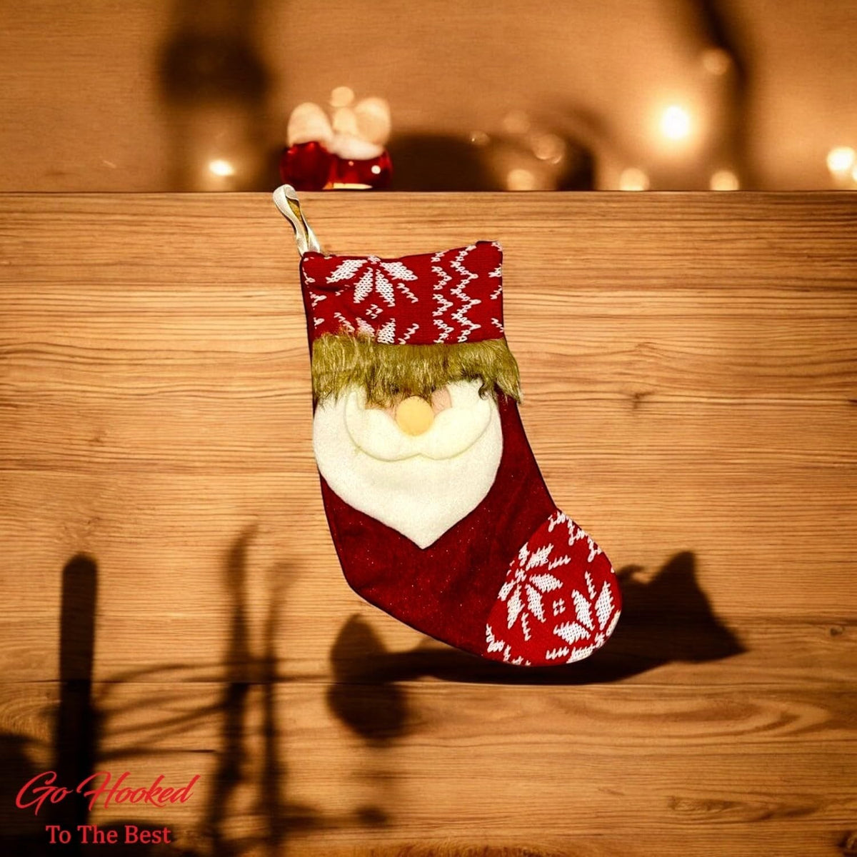 Go Hooked red Christmas stocking with Santa face, snowflake pattern, and faux fur trim. Festive decor for trees, walls, and doors.
