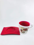 Go Hooked red ceramic cup-shaped planter with floral design and saucer, perfect for small plants.