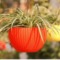GoHooked red woven-look plastic hanging pot with a spider plant. 7.1 inch diameter.
