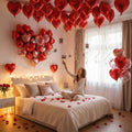 GoHooked red heart foil balloons and rose petals create romantic decor for proposals, anniversaries, and Valentine's Day.