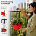 GoHooked round red plastic hanging planter with diamond pattern and metal chain held by a woman on a balcony