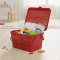Go Hooked red plastic picnic basket with lid, handle, and snap lock, filled with toys and essentials.