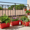 GoHooked Set of 3 red rectangular plastic plant pots with plants on a balcony.