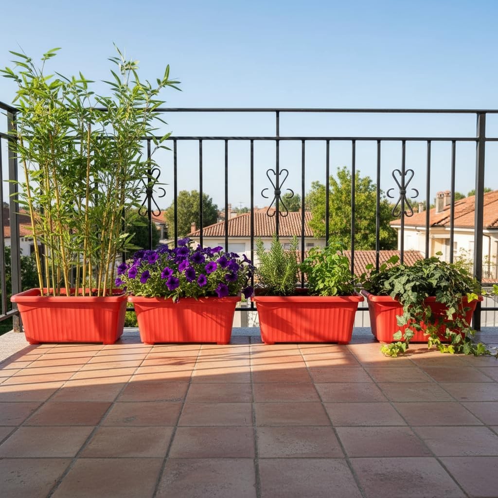 GoHooked set of 4 red rectangular plastic plant pots on a balcony with various plants including bamboo and purple flowers.
