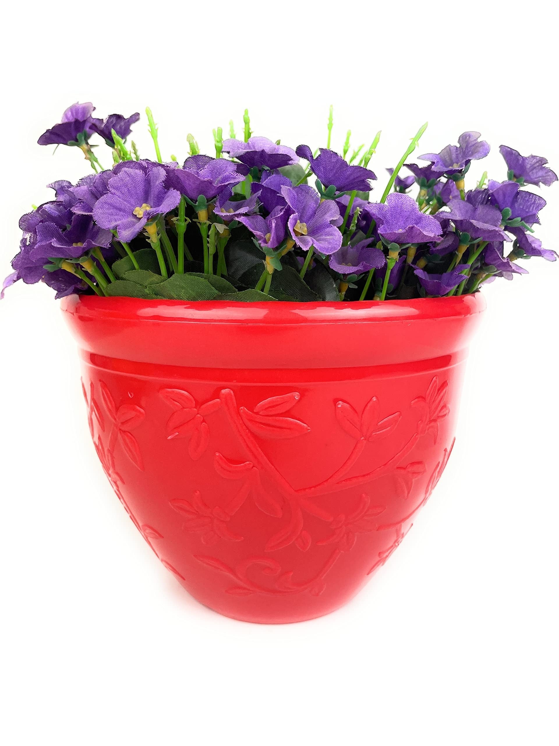 GoHooked red plastic planter pot with embossed floral design, filled with purple artificial flowers.