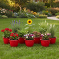 GoHooked red 10-inch plastic planters filled with various flowers and plants on a lawn.