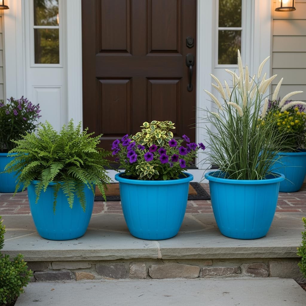 GoHooked set of 3 red plastic planters with decorative fluting, holding ferns, petunias, and ornamental grass on a porch.