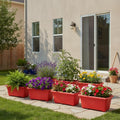 GoHooked Set of 4 red rectangular plastic planters filled with various flowers and plants on a stone patio.