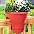 GoHooked 12-inch red plastic railing planter with white and yellow flowers, perfect for balconies.