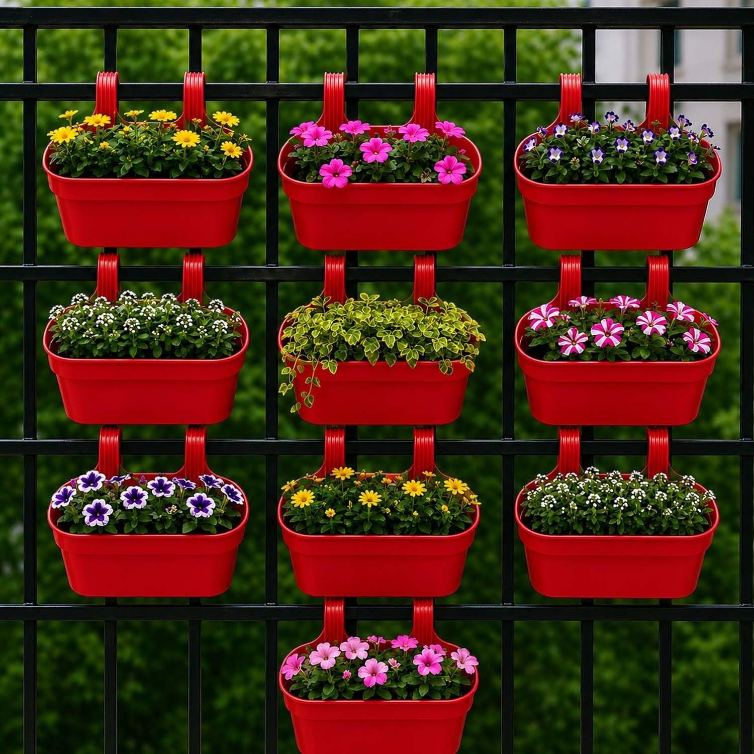 GoHooked red plastic railing hanging planters filled with colorful flowers and greenery on a black fence.