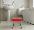 Go Hooked red plastic and steel multipurpose stool with a handle cutout, ideal for kitchen or bathroom.