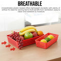 GoHooked red plastic storage baskets with ventilated grid design holding fresh fruit on a wooden table