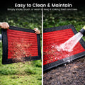 GoHooked red rubber door mat with ribbed texture being cleaned with water and shaken to remove dirt outdoors.