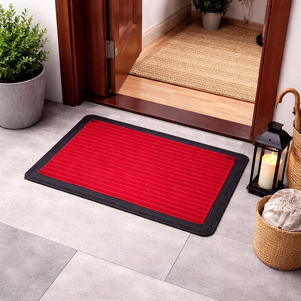 GoHooked red rubber door mat with ribbed texture and black border placed at a home entrance.