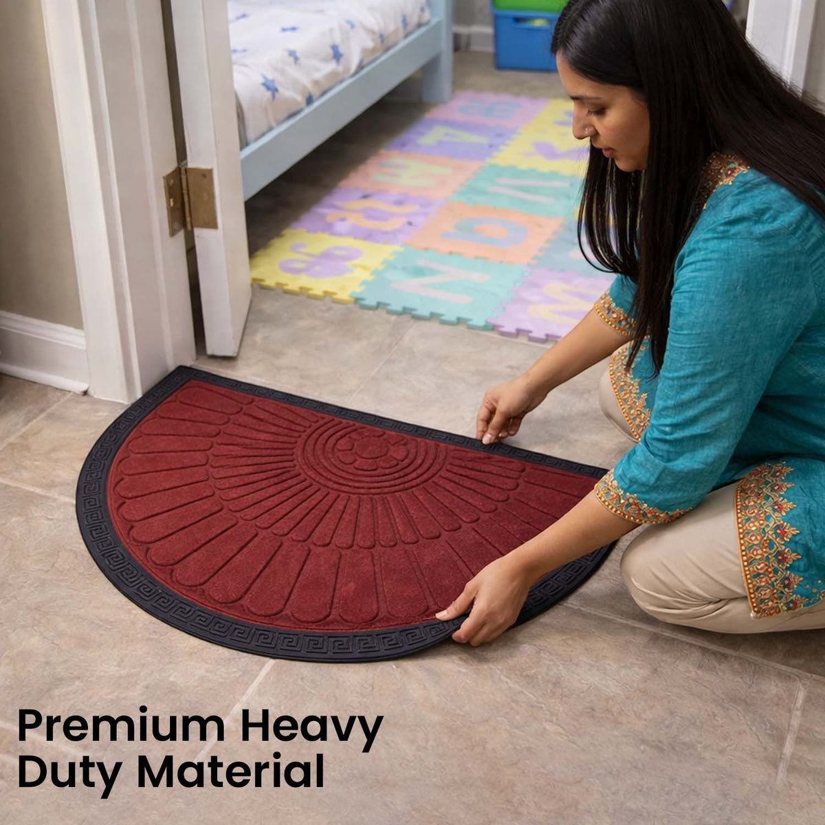 GoHooked red rubber half circle door mat with sunburst pattern and black border placed on a tiled floor by a woman.