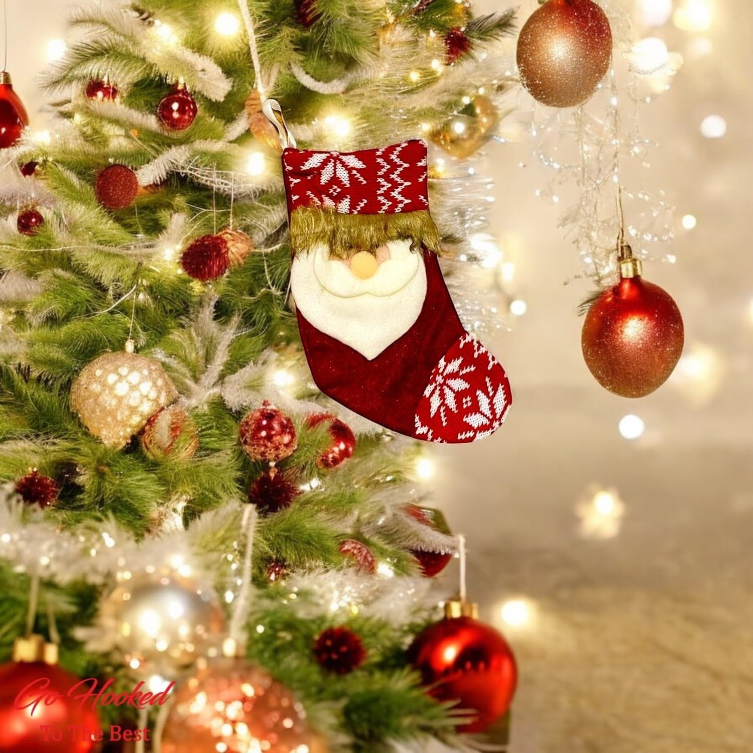Go Hooked red Santa Claus Christmas stocking with white snowflake pattern and faux fur trim, hanging on a decorated tree.