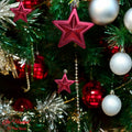 GoHooked red star Christmas ornaments with glitter accents, 3-inch, pack of 6, hanging on a decorated tree.