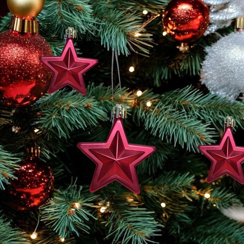 GoHooked red star Christmas ornaments with glitter accents, 3-inch, pack of 6, hanging on a decorated tree.